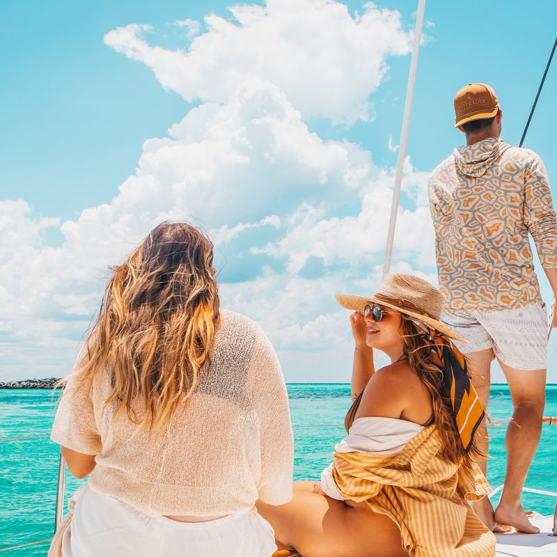People enjoying a private sailing charter on a calm open sea.