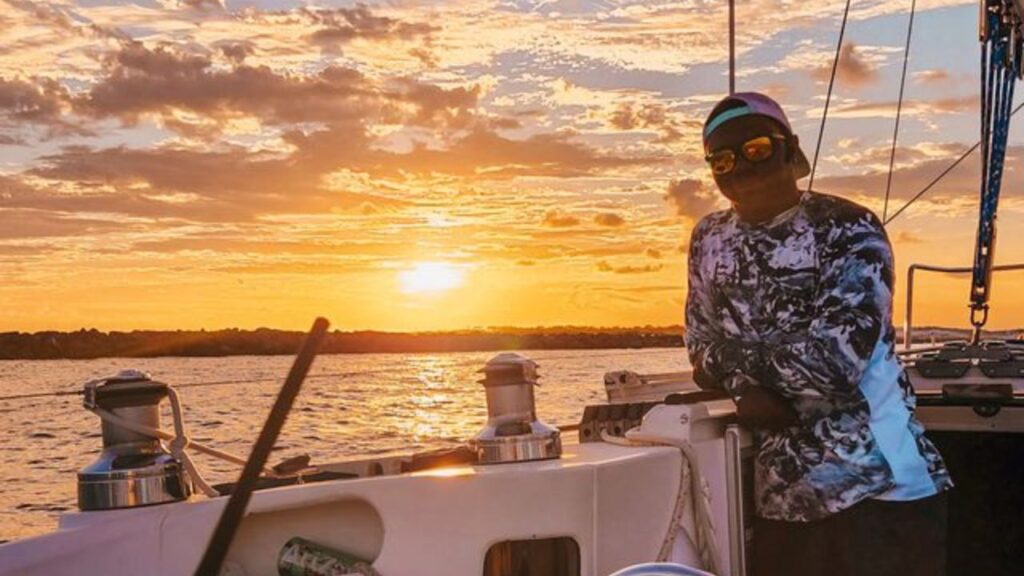 Man at sailboat during a private sailing charter on the Emerald Coast.