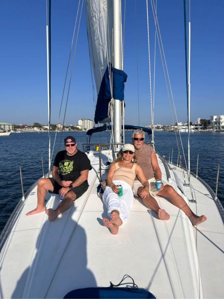 People enjoying the sunshine aboard a luxury sailing charter on the Florida Gulf.