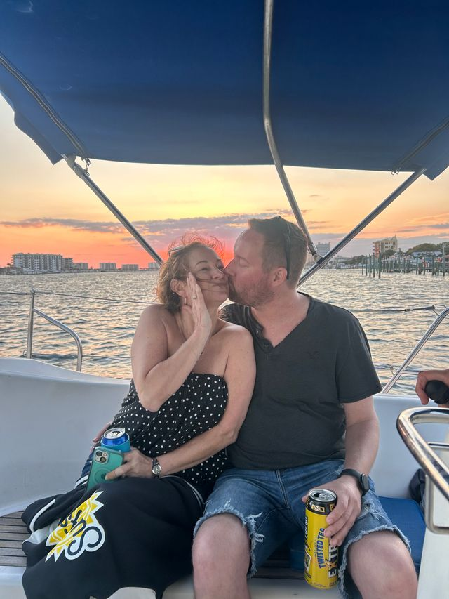 Couple enjoying a private sailing charter with calm ocean and sunset views
