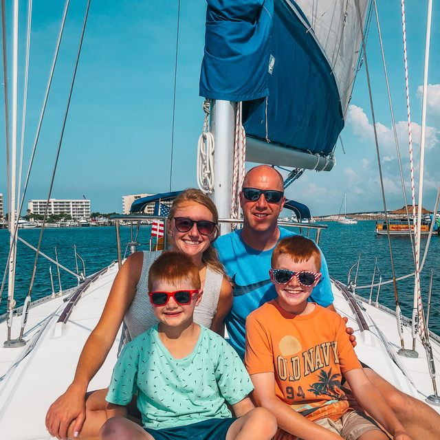 Family enjoying private sailing charter with kids on calm ocean waters