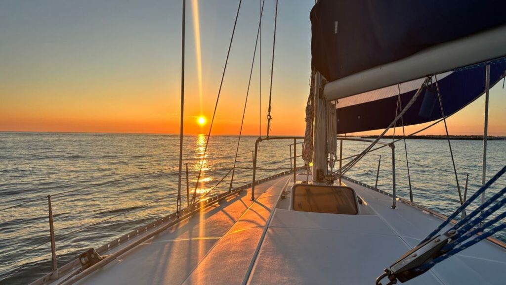 Private charter yacht sailing past the scenic Destin coastline on Florida's Emerald Coast.