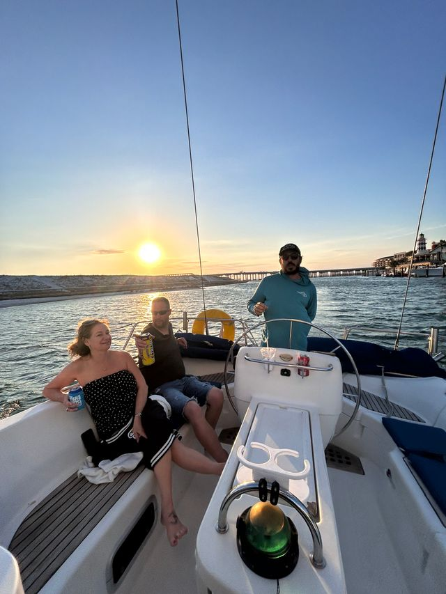 People relaxing aboard a private charter as the sun sets over Destin's coastal waters.