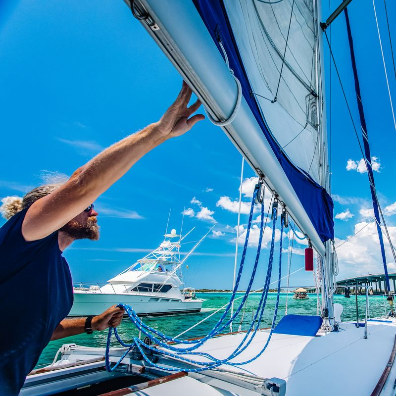 Captain adjusting the sails aboard a private sailing charter on Destin's Emerald Coast