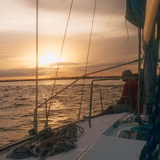 Scenic sunset view from a sailing charter boat on calm Gulf waters